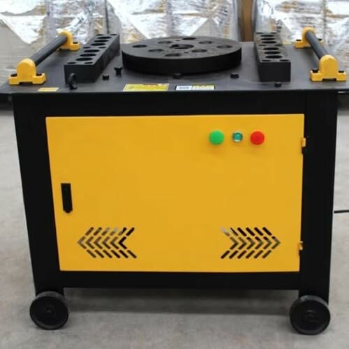 Yellow and black industrial metal bending machine on wheels.