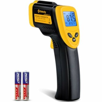 Infrared thermometer with backlit display and two AA batteries.