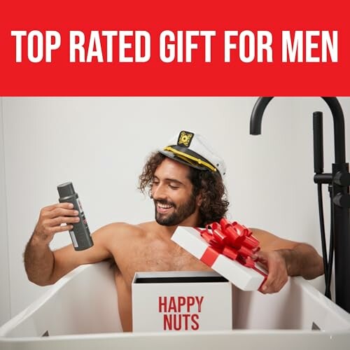 Man in bathtub holding grooming product and gift box labeled 'Happy Nuts'.